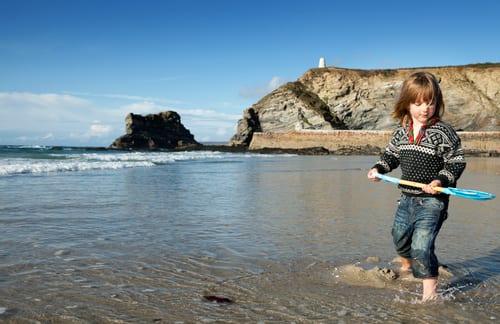 Child playing on the beach in Cornwall