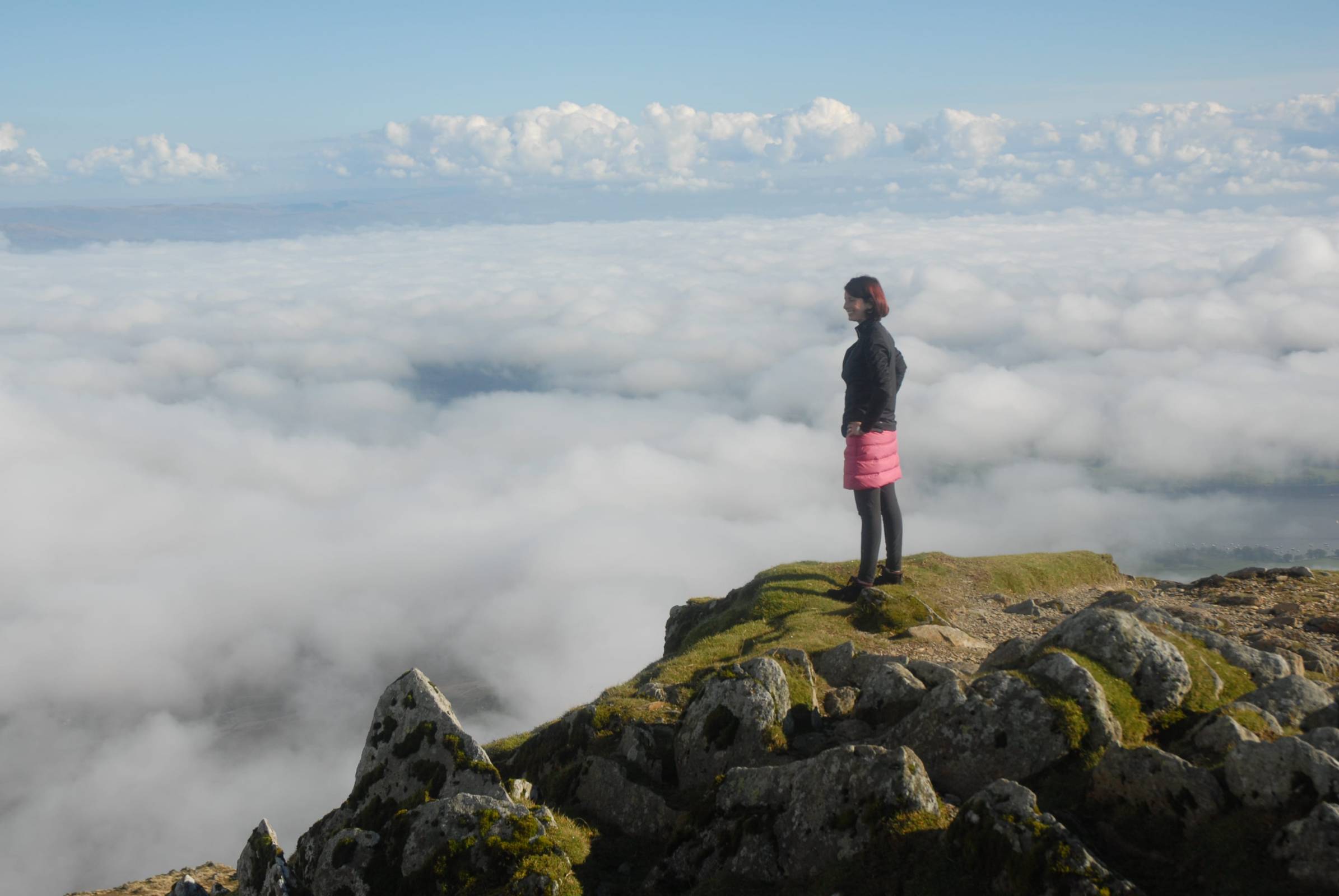 Person stood on top of a misty mountain