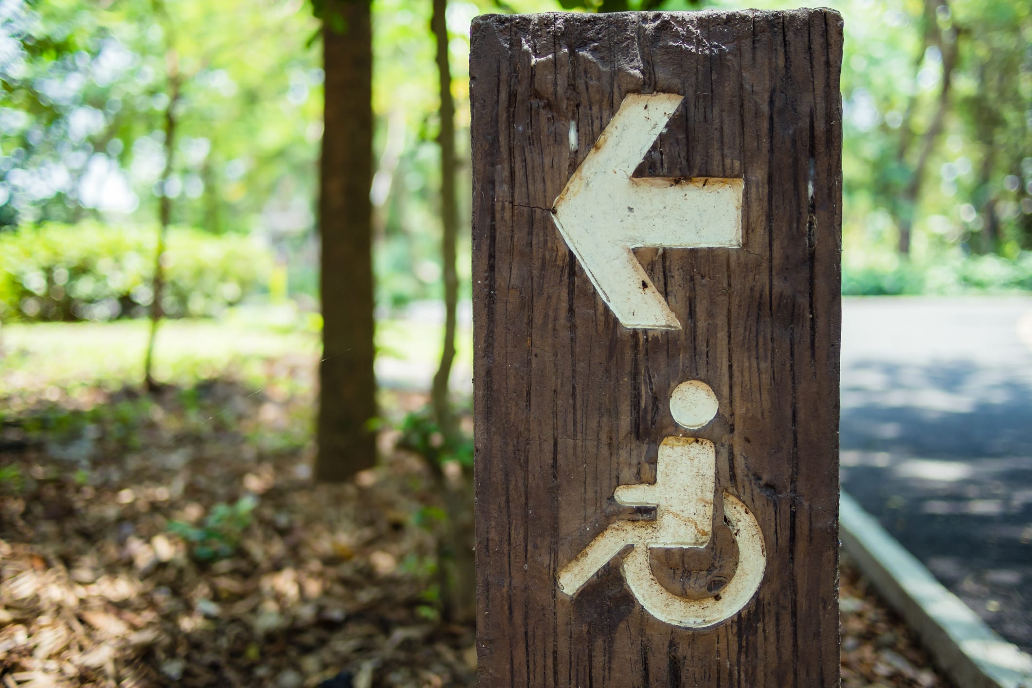 Wooden disabled way direction sign