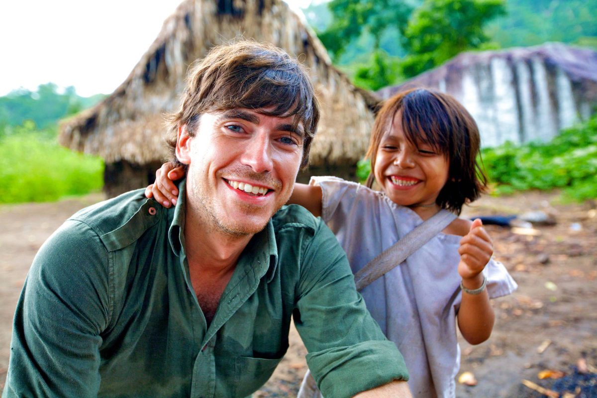 Simon Reeve with smiling child