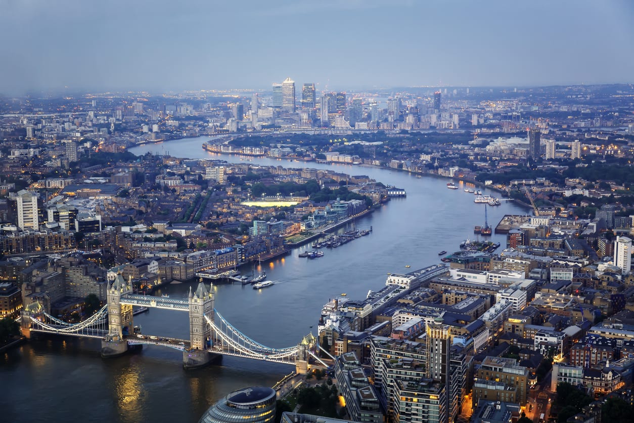 Aerial view of Tower Bridge and Canary Wharf skyline at night