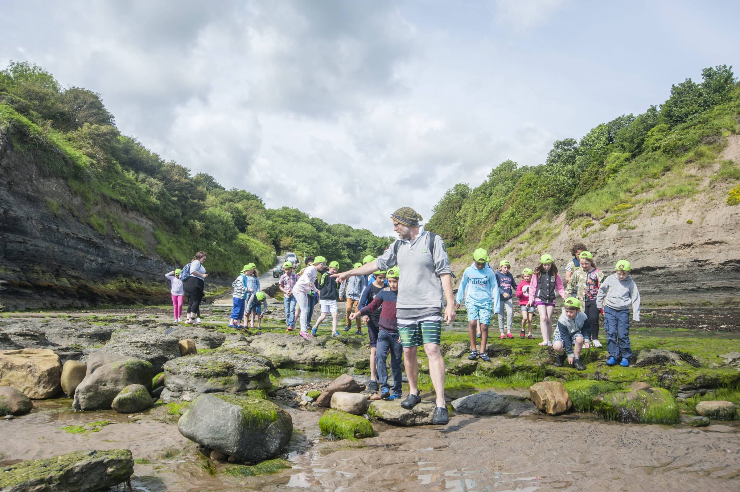 School group on a beach rock pooling