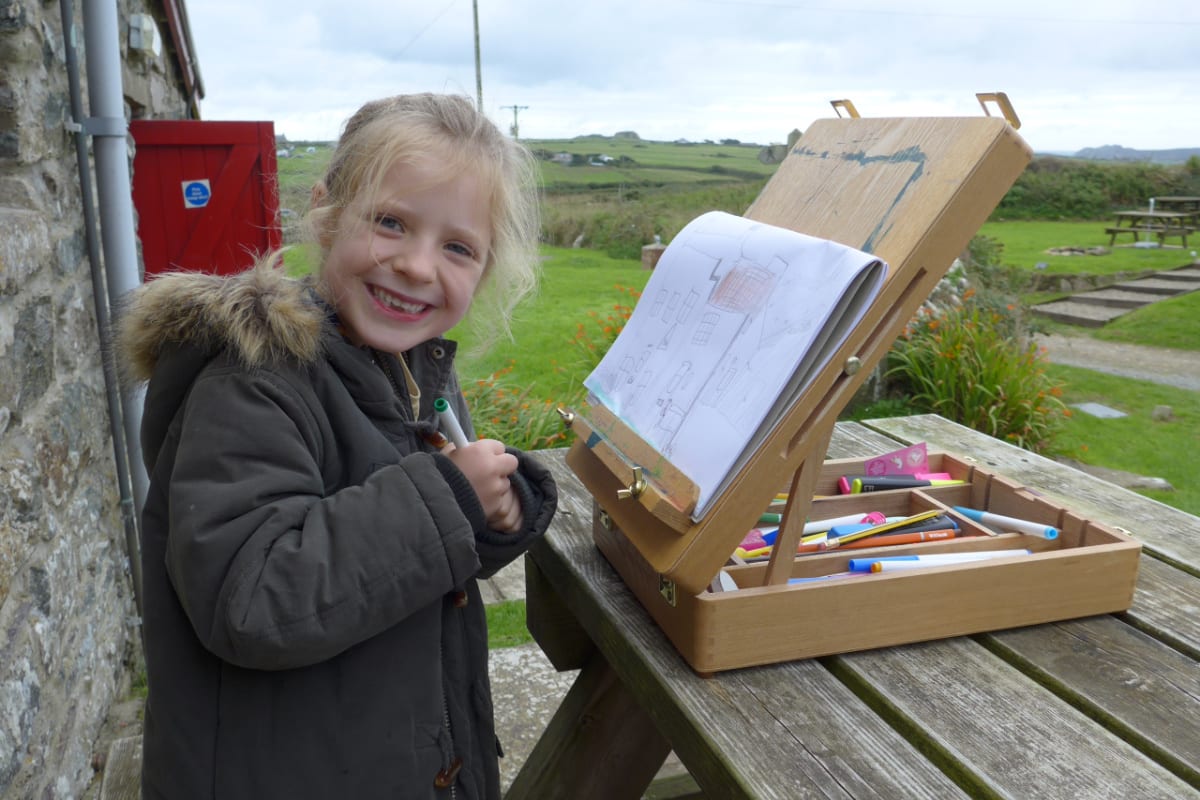 Child drawing in the countryside