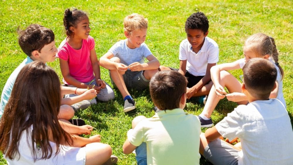 Group of children sat on grass