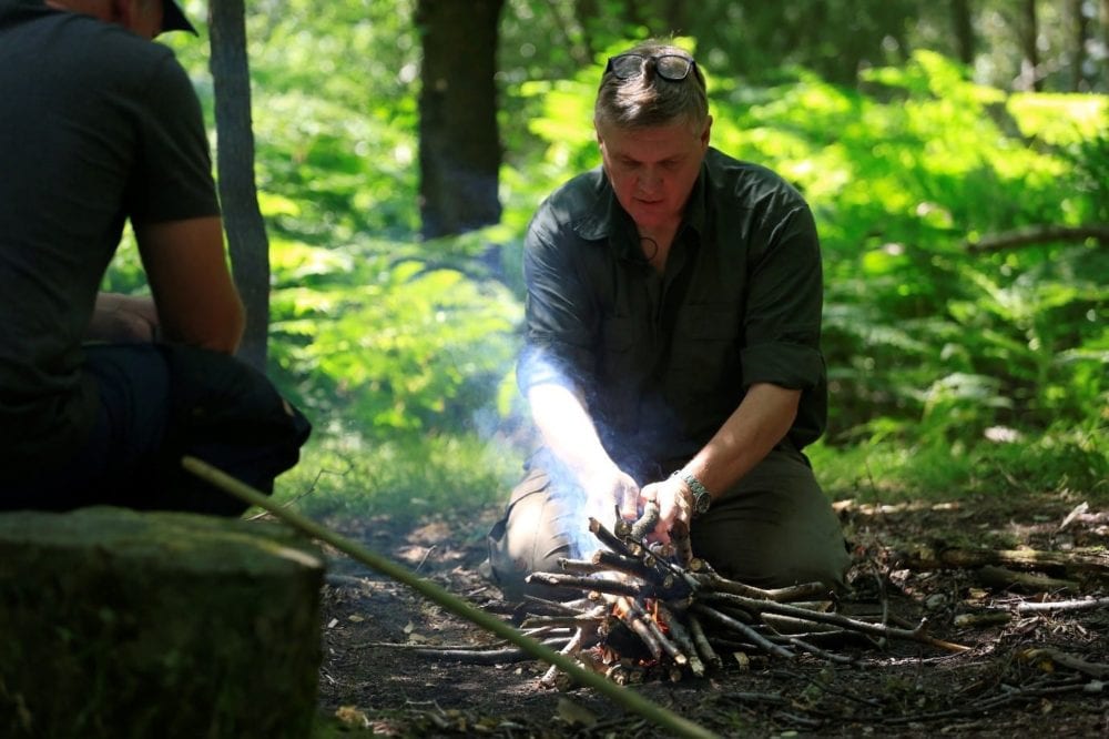 Ray Mears building a campfire in the woods