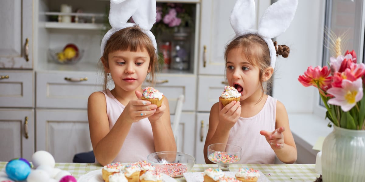 Two children eating cakes