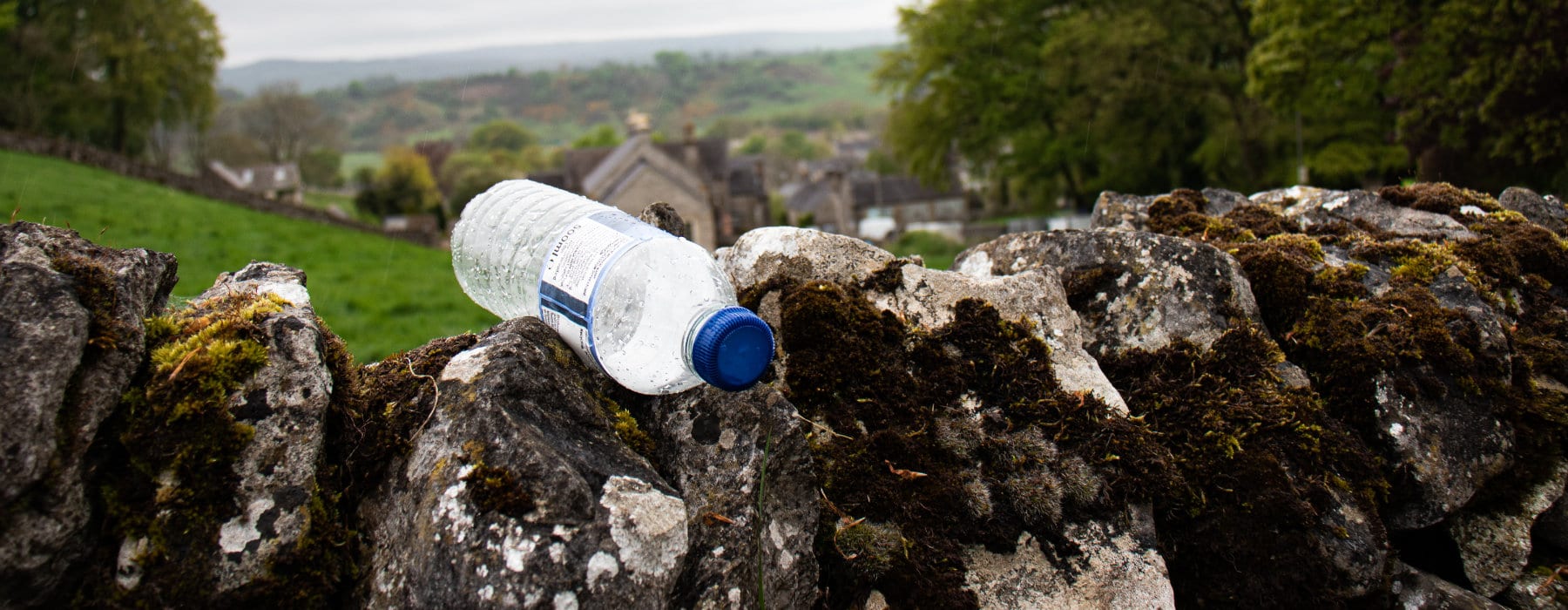 Plastic bottle on wall in countryside