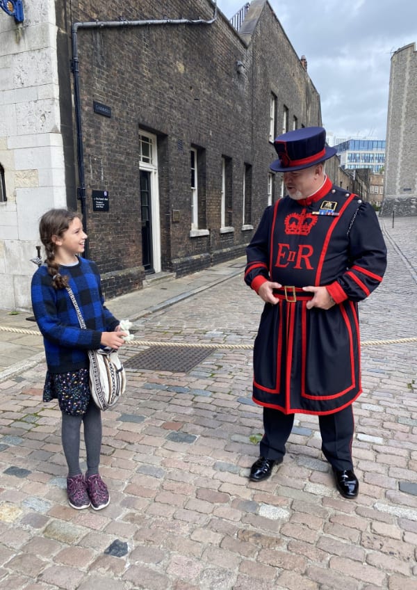 Child talking to Beefeater in London