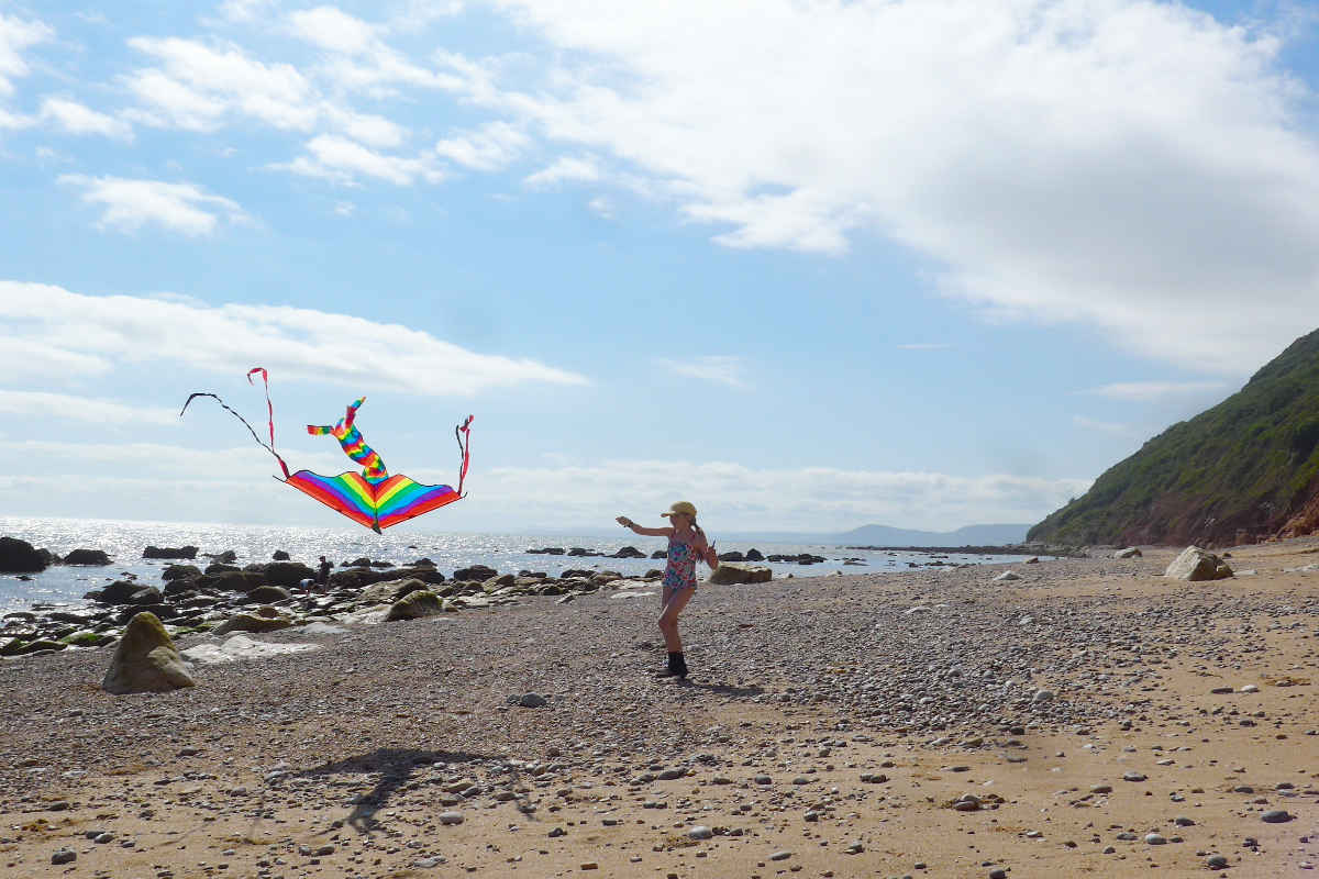 A girl flying a kite on the beach