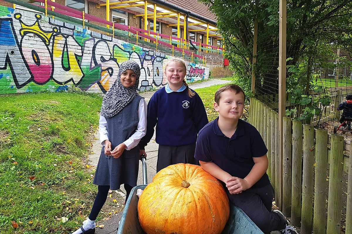Children with pumpkin in Moulsecoomb Forest Garden
