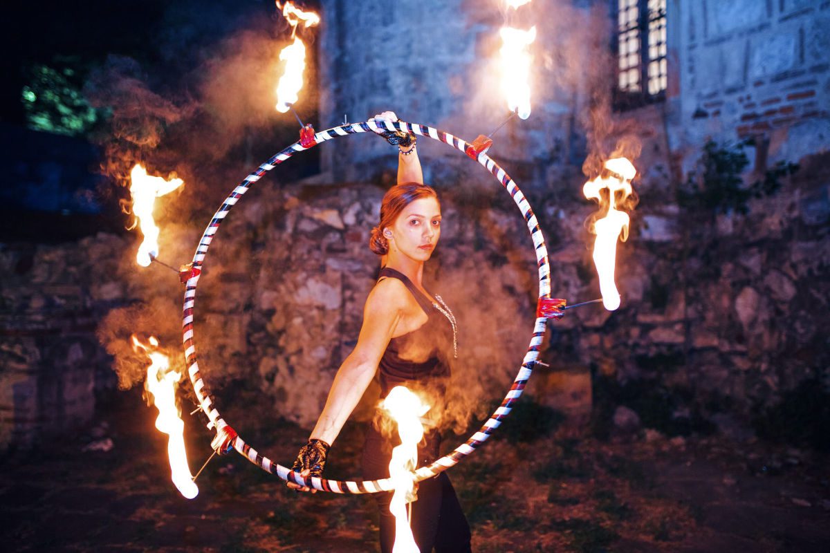 Circus performer standing in a flaming hoop