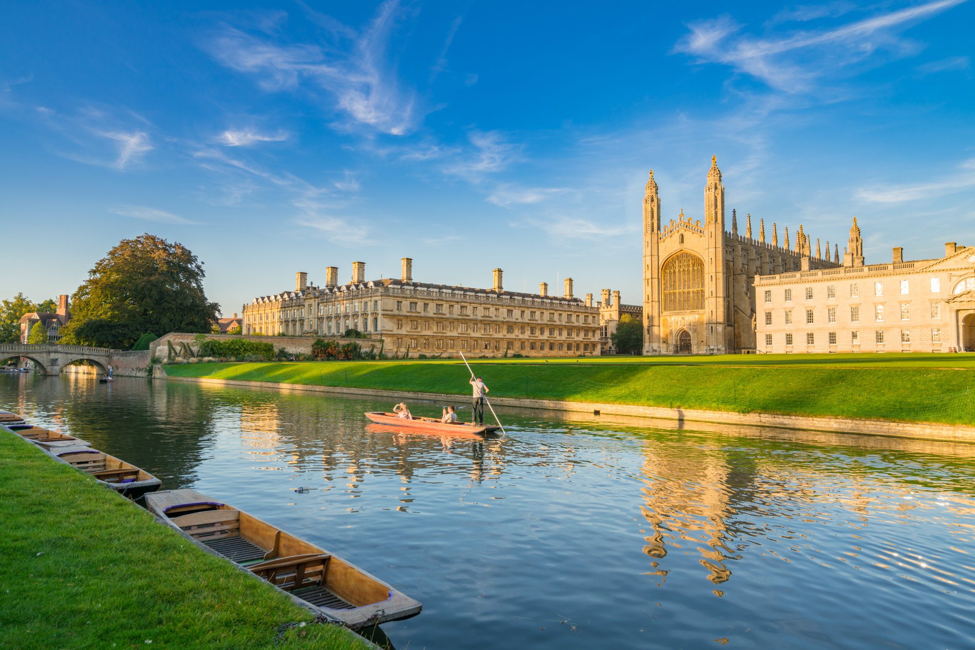 Beautiful view of college in Cambridge with people punting on river