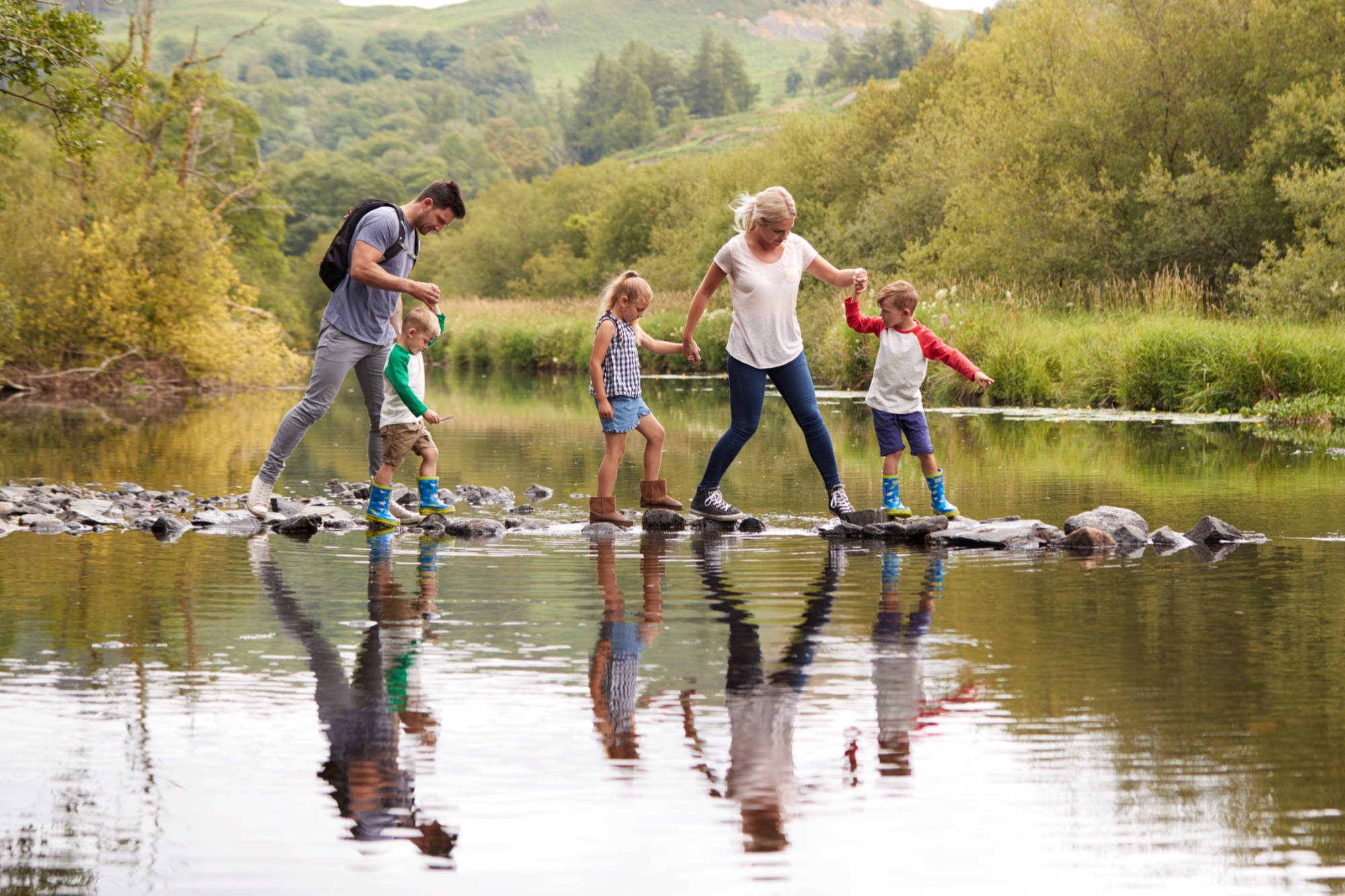 Family walking on stepping stones