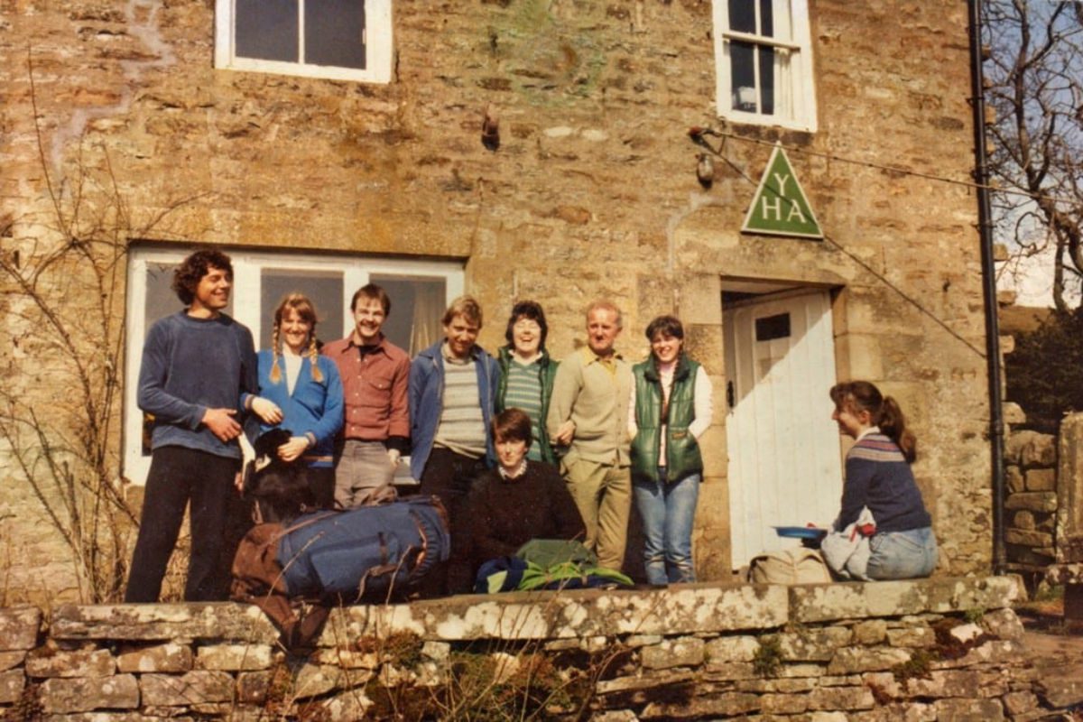 Group of travellers outside a hostel
