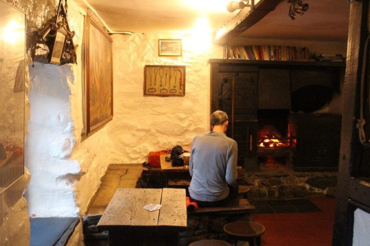 Person in a lounge area with fireplace