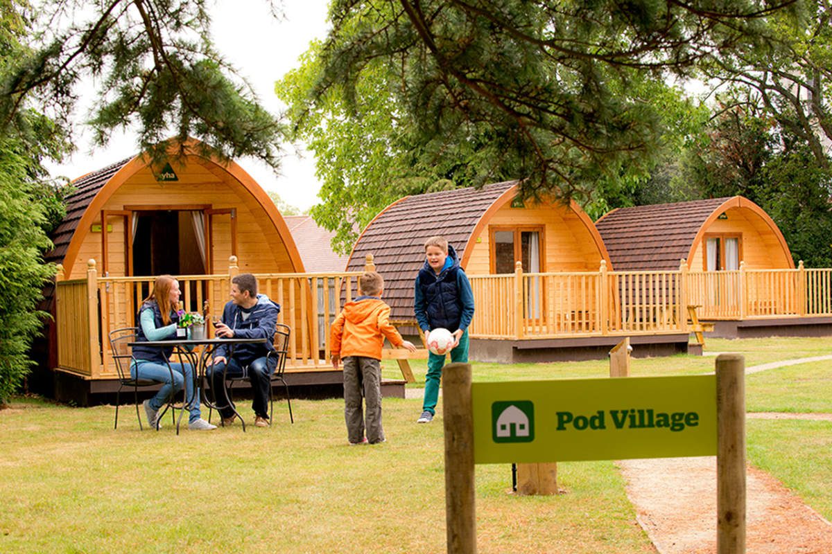 Family by camping pods at YHA Stratford-upon-Avon