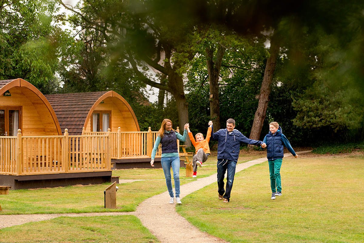 Family by camping pods at YHA Stratford-upon-Avon