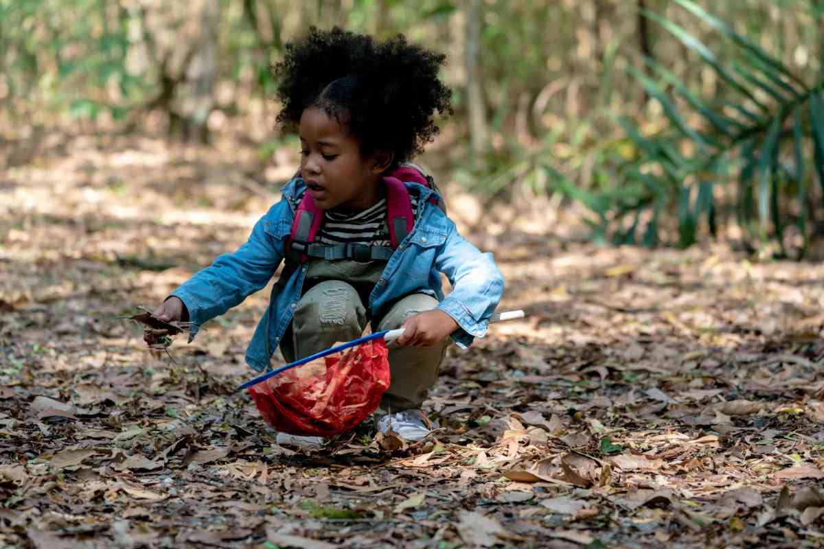 A girl collecting leaves outside
