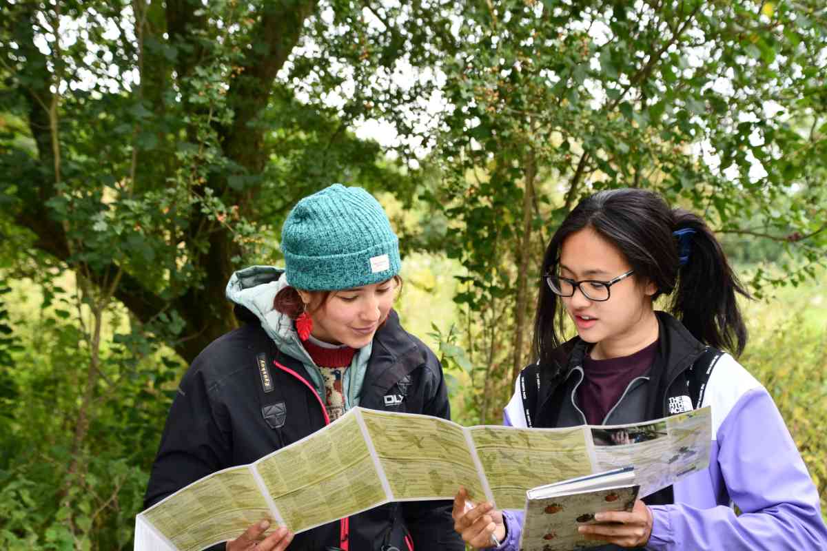 two girls looking at the wildlife guides 