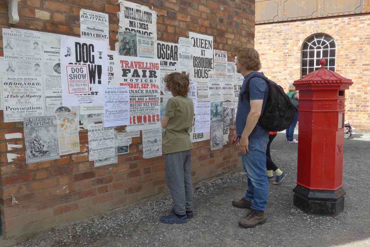 Father and son looking at the posters in Ironbridge