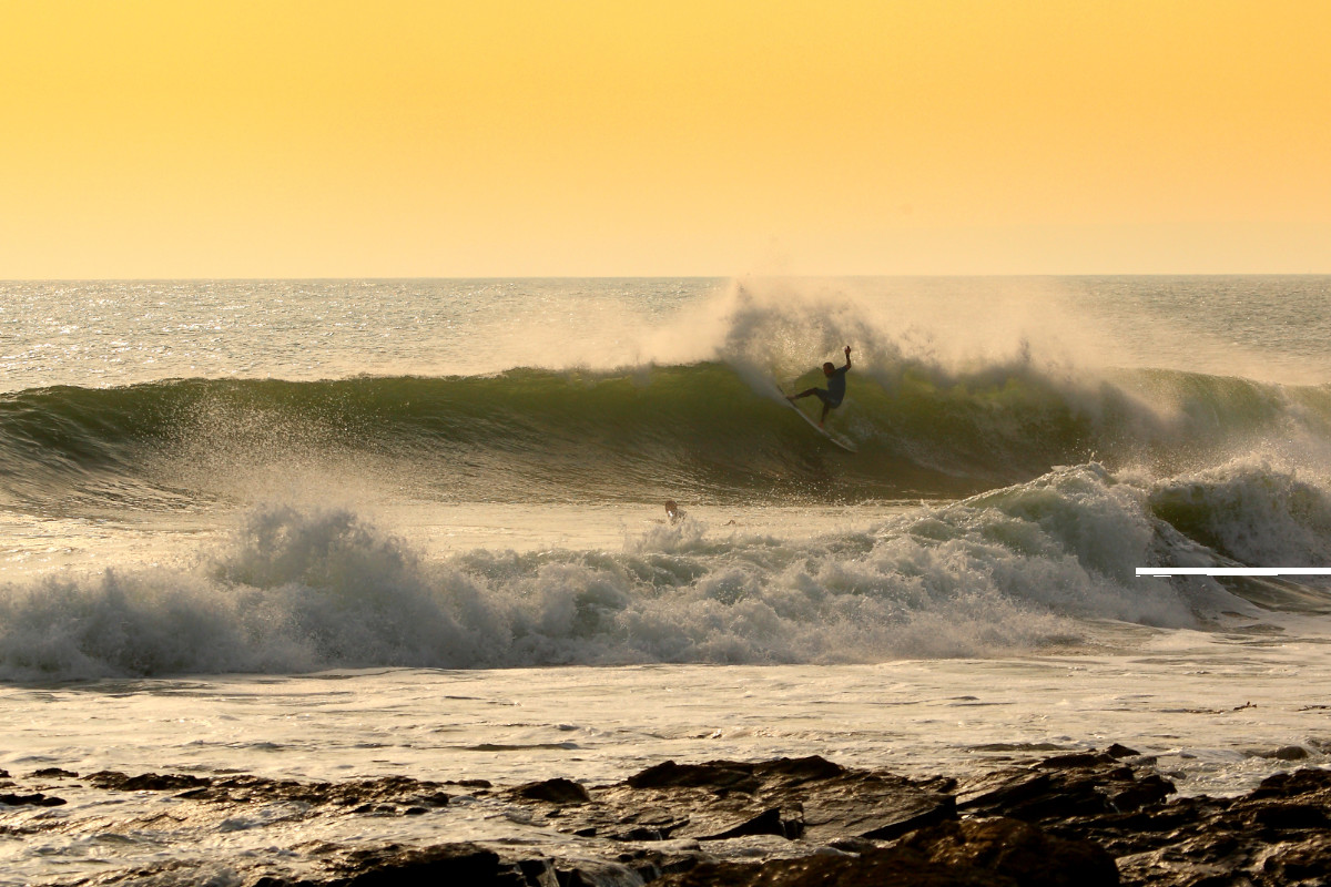 Surfer in Cornwall at sunset