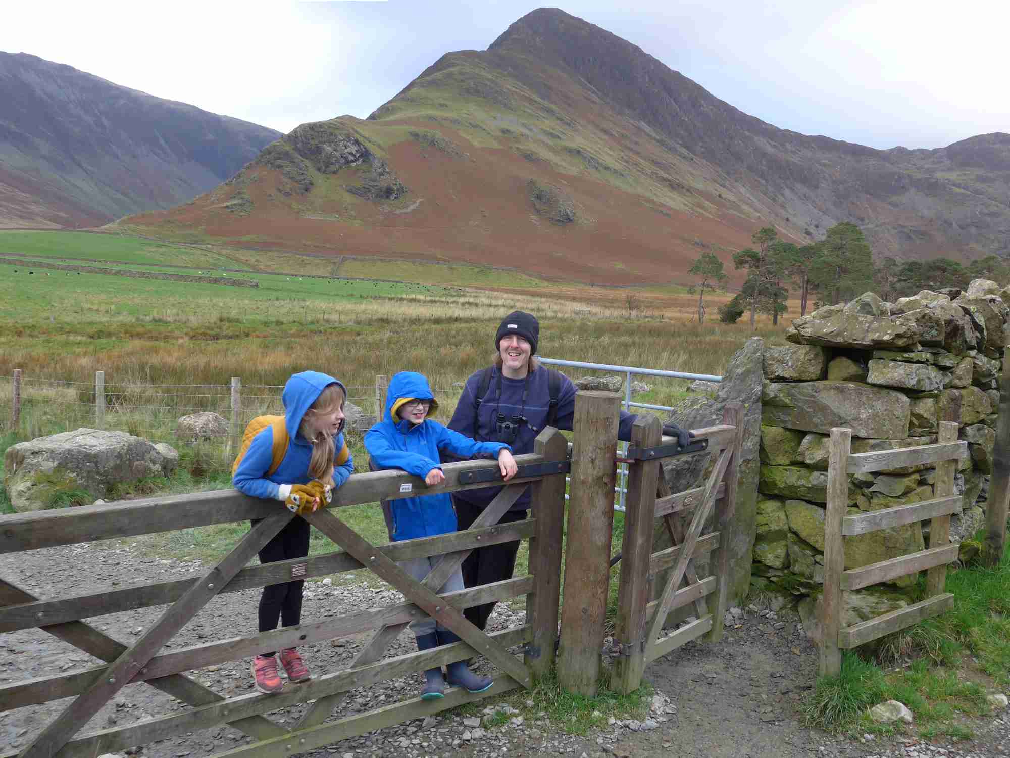 Jenny's family climbing a gate