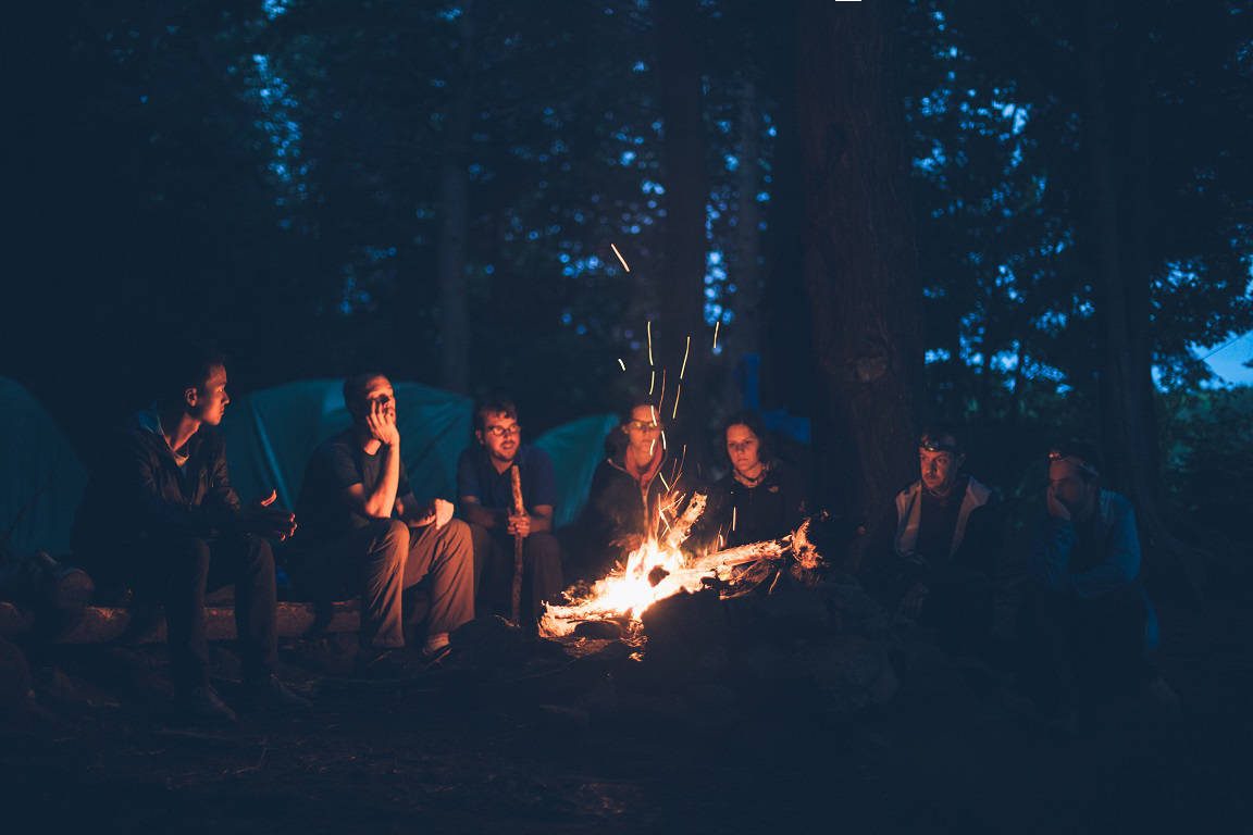 A group of friends around a campfire
