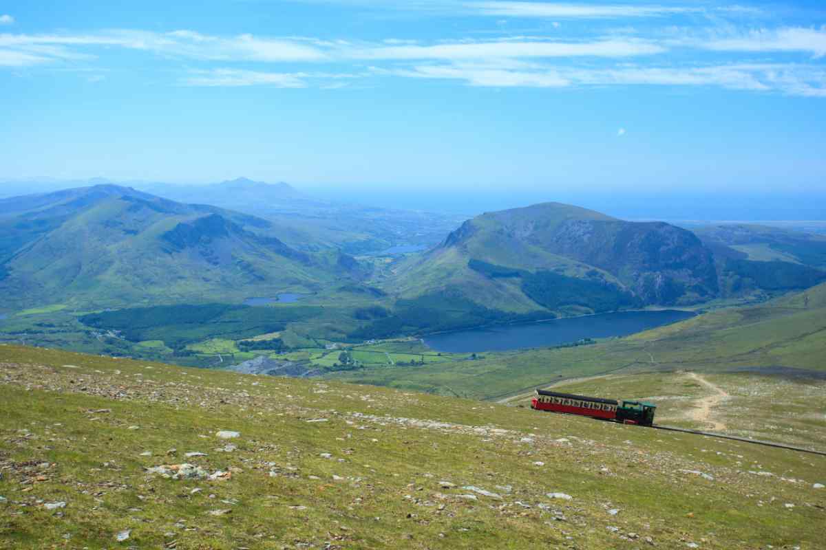 View from Snowdon on a bright sunny day with the Snowdon mountain railway carriage