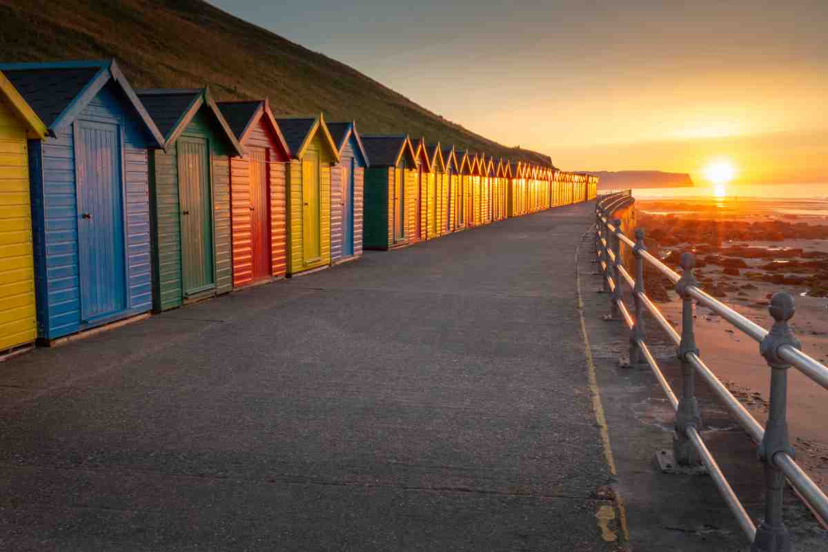 Whitby colourful beach huts on the promenade in North Yorkshire
