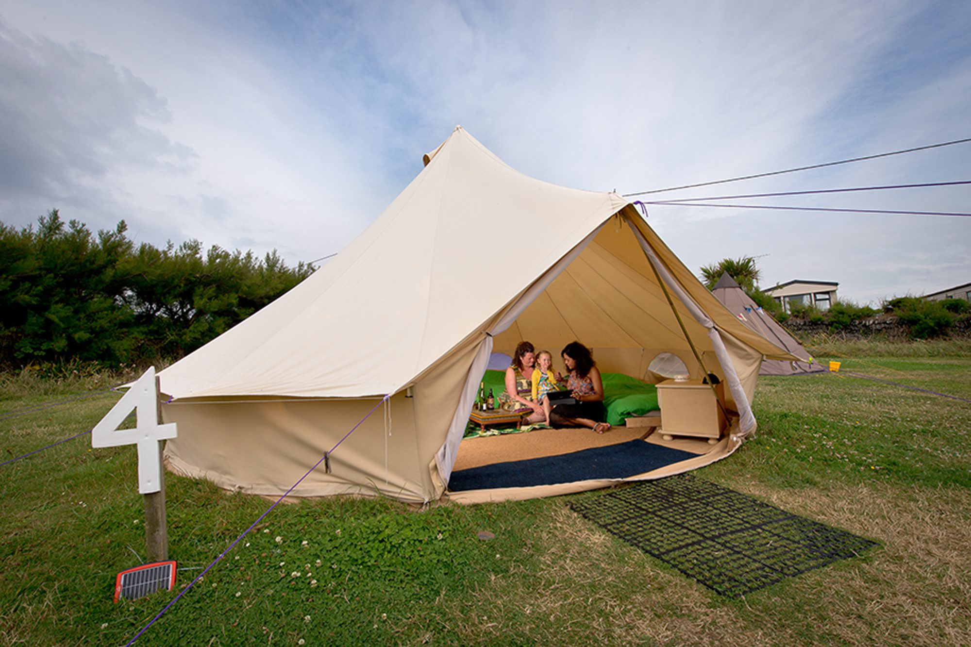 Family sitting in a YHA Bell Tent