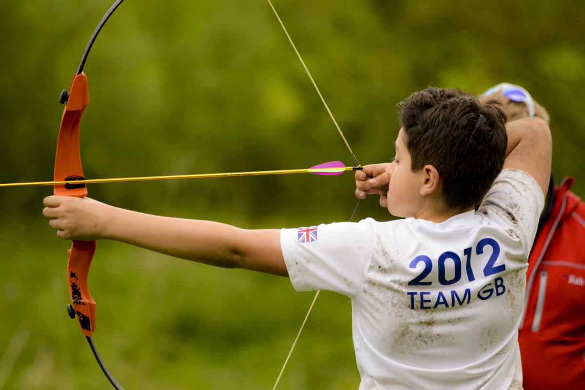 Child doing archery on a school trip