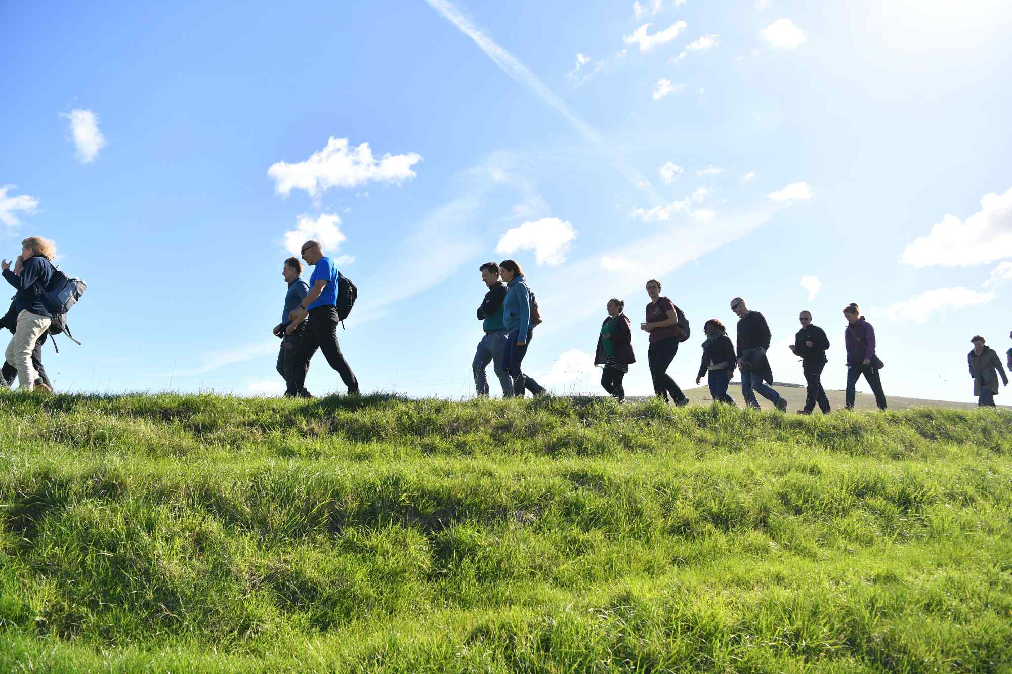 A group of walkers in the South Downs on a sunny day