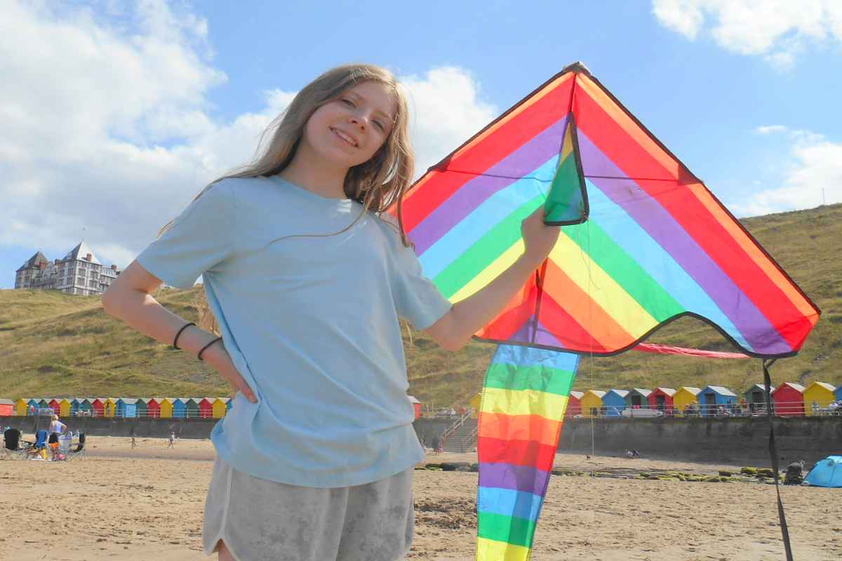 A girl with a kite on the West Cliff beach